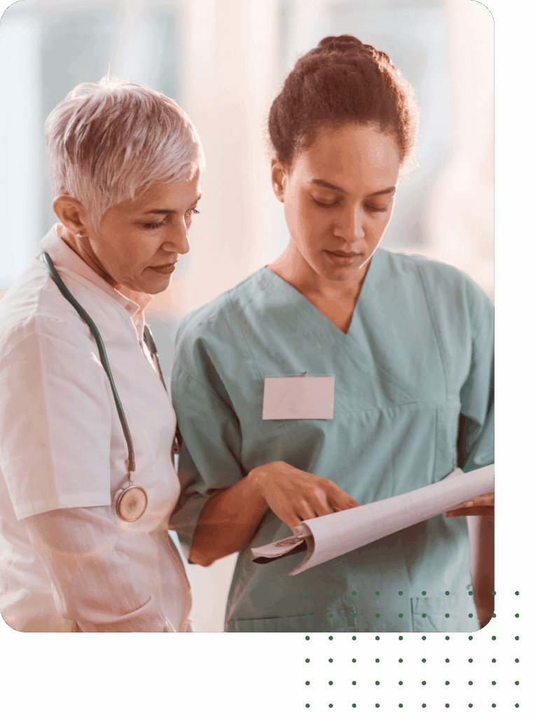 Two medical individuals looking at a chart