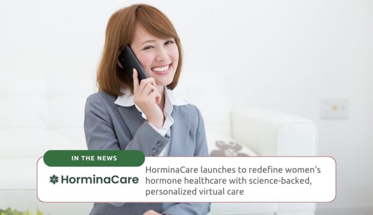 A woman smiling and talking on the phone.